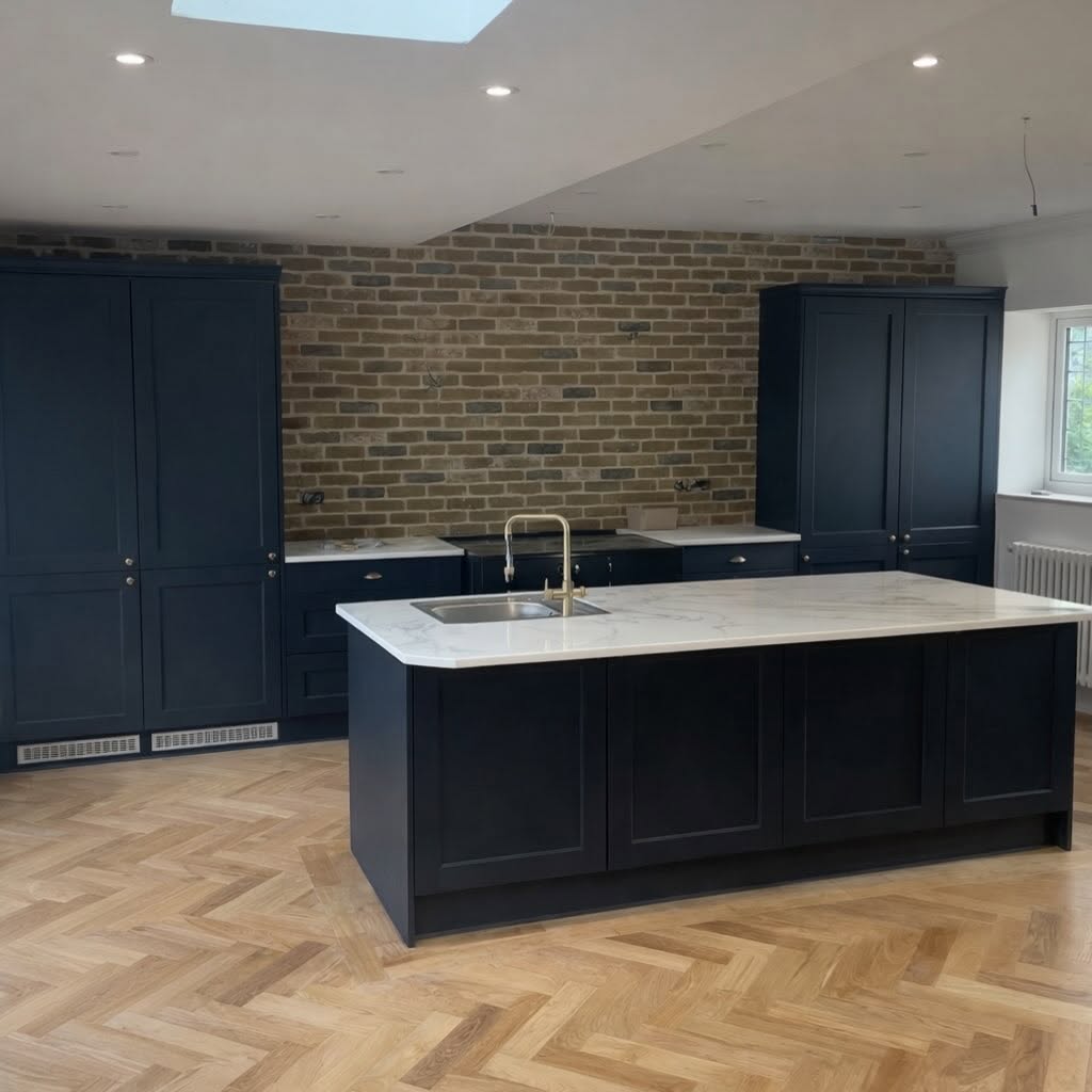 Navy shaker kitchen with marble island and herringbone floor built by Dex-Renovations