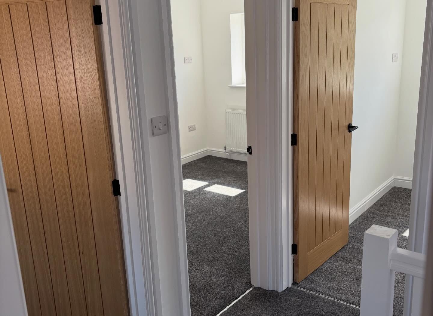 Oak bedroom doors and new grey carpet on a landing